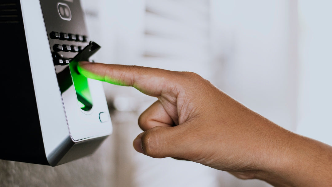 Finger swiping on a biometric scanner with a green light